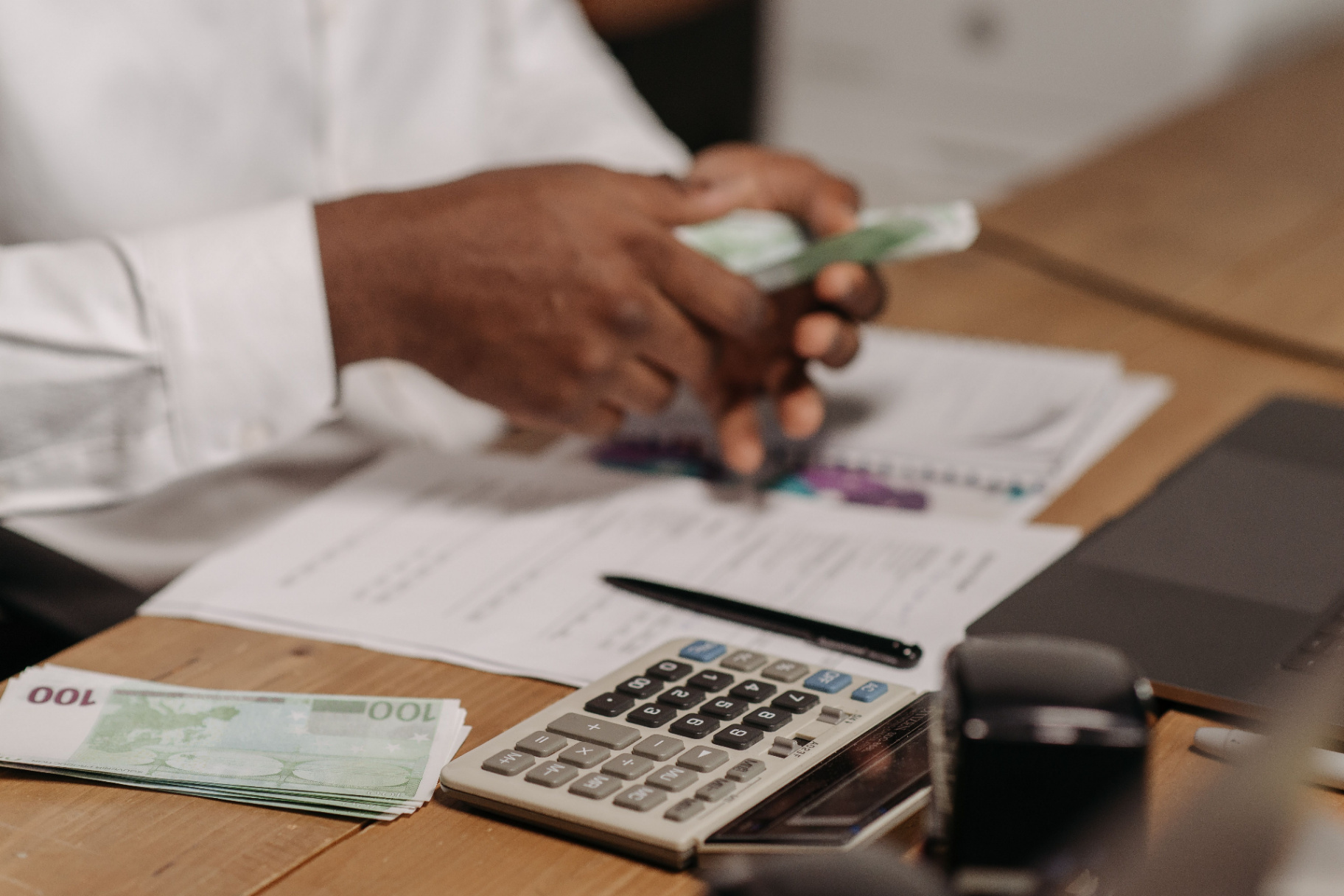 Auditor annotating a financial ledger